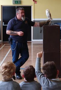 Man performing bird demonstration for children at Inchmarlo.
