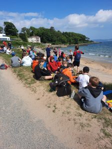 People enjoying a sunny day at Inchmarlo Beach in Scotland.
