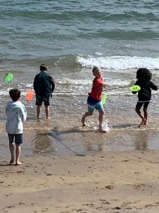 Children playing at Inchmarlo Beach in sunny weather. Perfect for family seaside outings and relaxing holidays.