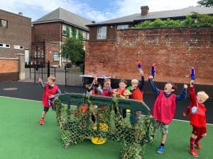Children playing happily at Inchmarlo early years playground.