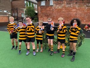 Young children in rugby uniforms at Inchmarlo school playground.
