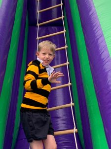 Child climbing inflatable play zone, outdoor fun at Inchmarlo.