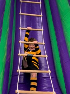 Child climbing indoor inflatable obstacle course at Inchmarlo.
