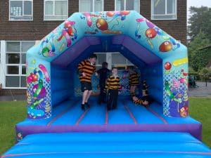 Colorful inflatable children's play tent with ocean-themed design for indoor and outdoor entertainment.