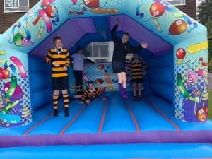 Colorful inflatable bouncy castle for children at Inchmarlo outdoor event.