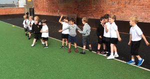 Children playing on a green playground at Inchmarlo School, promoting fun and outdoor learning.