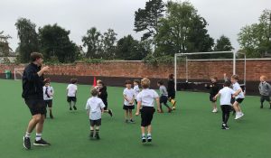 Children playing on outdoor sports field at Inchmarlo School.