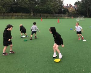 Children playing on outdoor sports field at Inchmarlo school.