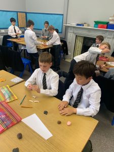 Students engaged in class activity with educational materials.