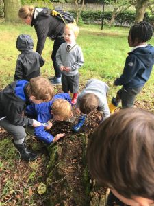 Children exploring outdoors at Inchmarlo, engaging in educational nature activities in a lush park setting.