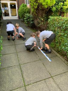 Children drawing on outdoor pavement at Inchmarlo.