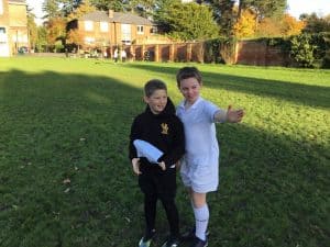 Beautiful outdoor space at Inchmarlo with lush greenery and children enjoying the garden.