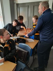 Students engaging with a teacher during classroom activity at Inchmarlo School.