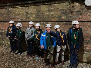 Children participating in outdoor adventure activities at Inchmarlo, promoting teamwork and outdoor fun.