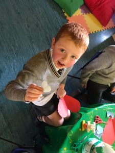 Happy kid playing in Inchmarlo’s kids' indoor play zone with colorful toys and games.