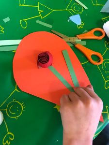 Colorful craft project with scissors and paper arrangement.