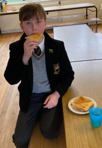 Young student enjoying a snack at school in Inchmarlo.