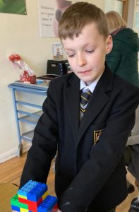 Young student in school uniform engaging in classroom activities at Inchmarlo.