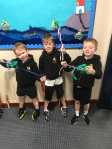 Three children holding fishing rods at Inchmarlo, enjoying outdoor activities.