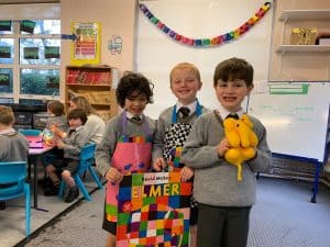 Happy children with gifts in classroom.