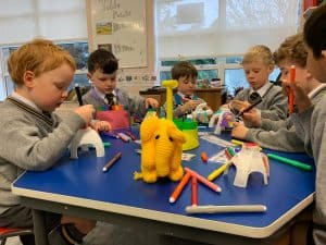 Children engaging in creative play at Inchmarlo nursery in Scotland.