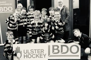Child hockey team celebrating victory at Inchmarlo Sports Complex, Scotland.
