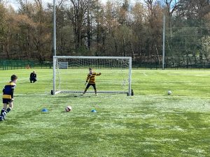 Young children playing soccer at Inchmarlo outdoor sports field.