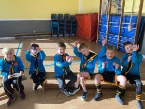 Young children in sports uniforms at Inchmarlo school indoor gym.
