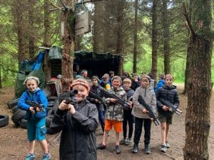 Group of kids enjoying outdoor adventure at Inchmarlo Nature Reserve in a forest.