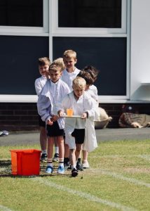 Children playing cricket outdoors at Inchmarlo School.