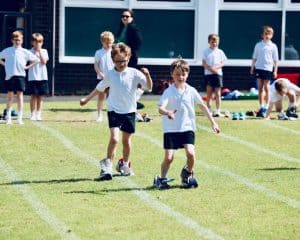 Students playing outside at Inchmarlo School in Scotland, engaging in outdoor activities and sports.