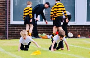 Young children playing on school field, outdoor fun at Inchmarlo Educational Centre.