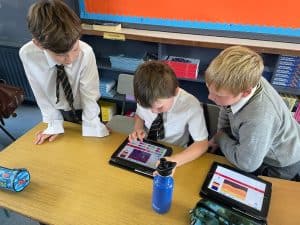 Students using tablets in classroom.