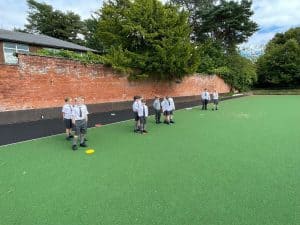 Students playing on the school sports field at Inchmarlo, showcasing education and recreational facilities.