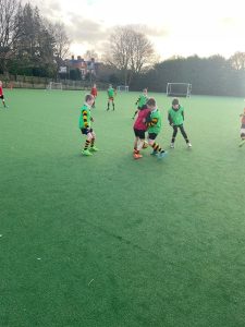 Children playing football at Inchmarlo School sports field.