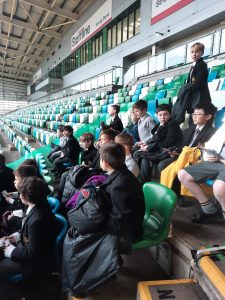 Visitors watching a sports event at Inchmarlo sports facility with seating stands.