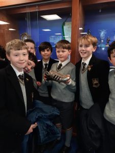 Group of cheerful students in school uniforms at Inchmarlo, showcasing education and community spirit.
