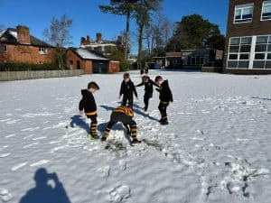 Children playing in the snow at Inchmarlo school playground.