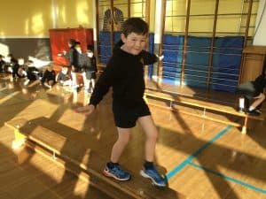 Young boy enjoying indoor gym activities at Inchmarlo School.