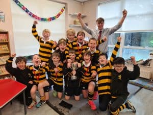 Happy children in graduation gowns at Inchmarlo School, showcasing academic success and student celebration.