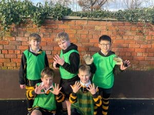 Group of children in school uniforms outdoors at Inchmarlo, enjoying a school trip or outdoor activity.