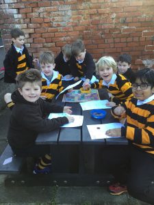 Group of children playing educational games outdoors at Inchmarlo, enhancing learning and social skills.