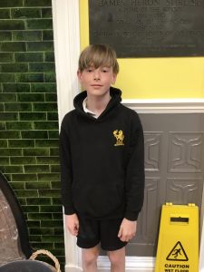 Young boy standing outdoors at Inchmarlo estate, highlighting scenic grounds and natural beauty.