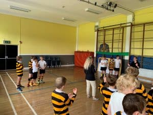 Children engaging in indoor sports at Inchmarlo facility.