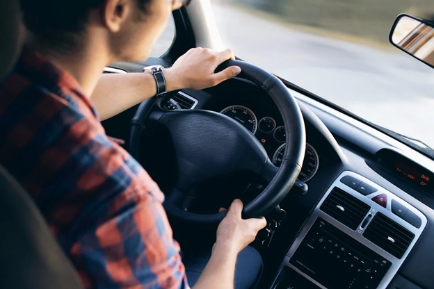 Person driving a car focusing on eco-friendly driving practices.