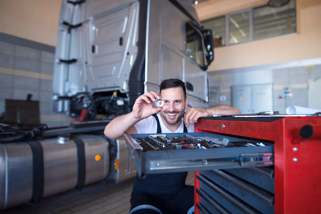 vehicle-mechanic-standing-by-tools-cart-holding-spare-part-truck-service