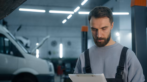 auto-mechanic-professional-technical-expert-caucasian-man-male-checking-car-manual-maintenance-write_717737-31725.avif