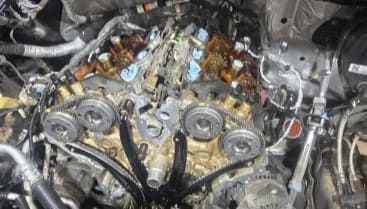 Detailed view of a car engine undergoing repair at Izzy's Blue Auto LLC.