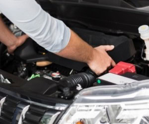 Engine inspection during auto repair service.