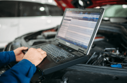 Technician diagnosing suspension system in a vehicle at Jimmy's Auto Repair.